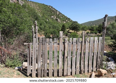 wooden fenced area in the countryside