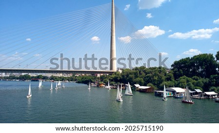 Drone view of bridge, river and boats at summertime - Belgrade, Serbia. Royalty-Free Stock Photo #2025715190