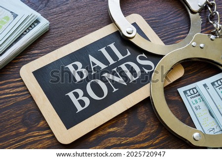 Plate Bail bonds and handcuffs on it. Royalty-Free Stock Photo #2025720947