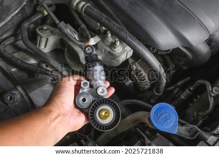 Close-up of automotive drive belt tensioner and pulley. Royalty-Free Stock Photo #2025721838