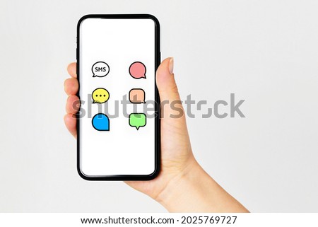 Smart Phone with messenger chat screen. Sms template bubbles for compose dialogues. Closeup woman hand holding smart phone.Chating and messaging concept.