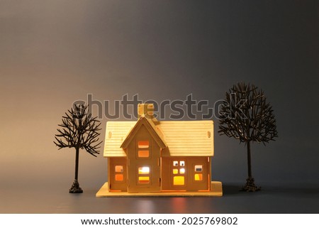 Bright wooden house with autumn trees against night black background with moonlight. Halloween theme