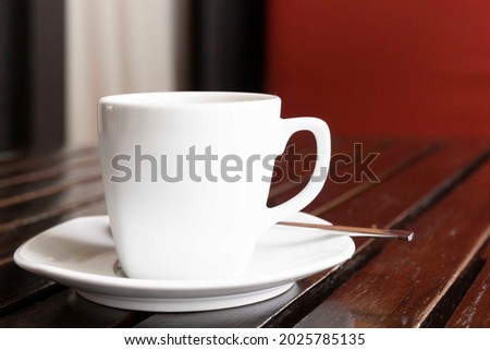 The coffee mug placed on brown wood table 