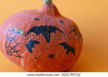 Close-up of a Halloween pumpkin isolated on an orange background