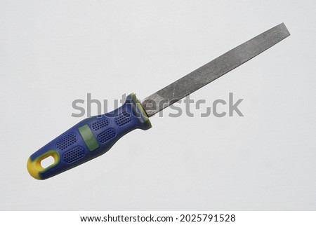 Iron file tool with blue handle on isolated white background                            Royalty-Free Stock Photo #2025791528