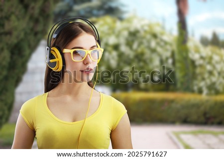 Happy relaxed woman resting listening to music with headphones in a forest