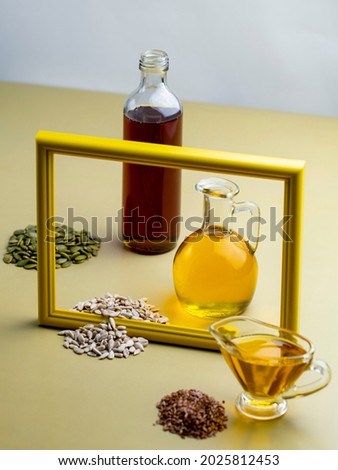 Seeds of pumpkin, sunflower, flax and pumpkin, sunflower, linseed oil in different glass vessels. Vegetable oils concept. Vegetarian diet foods rich in omega-3s and vitamins A, E, F, selective focus