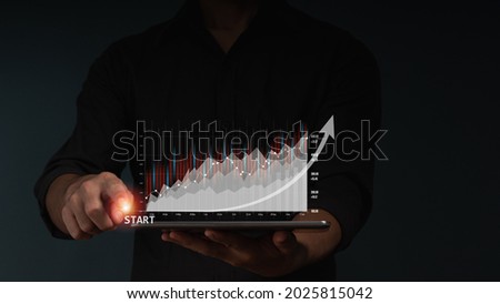 The concept of Finance analyst. The businessman analyzing stock market trend with stock graph and forex graph on tablet computer virtual screen.