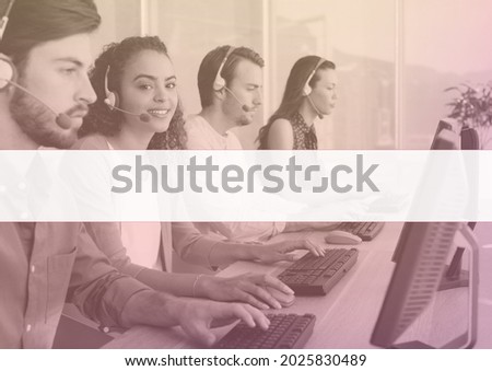 Composition of business people wearing headsets and using computers in office. employment template concept digitally generated image.