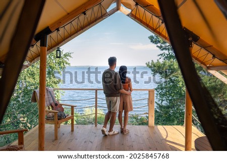 rear view of affectionate couple enjoying summer vacation in glamping house Royalty-Free Stock Photo #2025845768