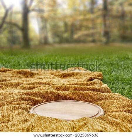 Brown blanket with kitchen desk on grass and autumn landscape. Free space for your decoration 