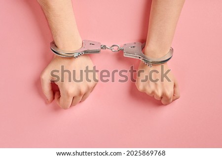 Male and female hands in handcuffs. Love forever. Prenuptial agreement, duties of love couple. Royalty-Free Stock Photo #2025869768