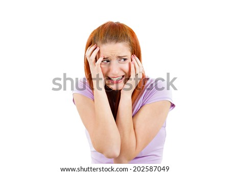 Closeup portrait anxious woman, employee, student, worker funny looking female, shocked, scared trying to protect herself in anticipation unpleasant situation, isolated white background. Human emotion
