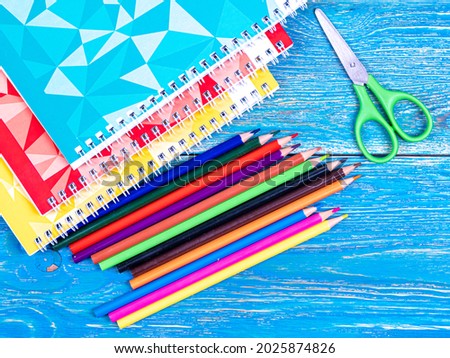 Colored pencils and notebooks on a wooden table. September 1. Design. Background