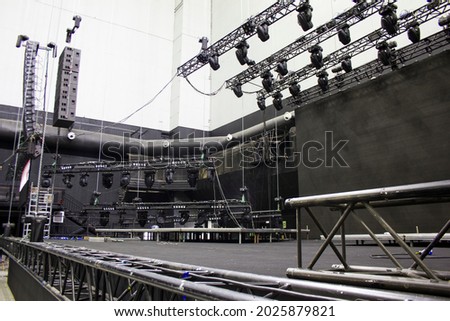 Installation of professional sound, light, video and stage equipment for a show. Technical preparing for the concert. Royalty-Free Stock Photo #2025879821