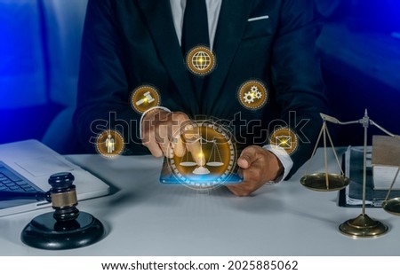 Lawyer hands working with digital tablet and laptop computer on table office. Law innovation network icons, blurred background.