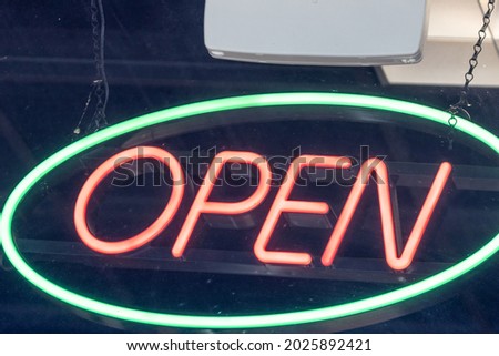 neon red and blue open sign in window