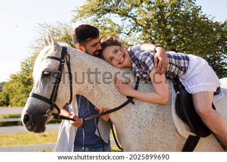 The young couple are having fun time with horse