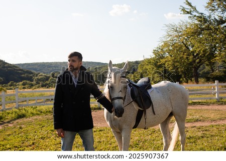 Man with a horse on a background of beautiful nature
