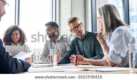 Diverse business people partners group negotiating at boardroom meeting.Multiethnic executive team discussing financial partnership agreement project strategy brainstorming sitting at table in office. Royalty-Free Stock Photo #2025930410