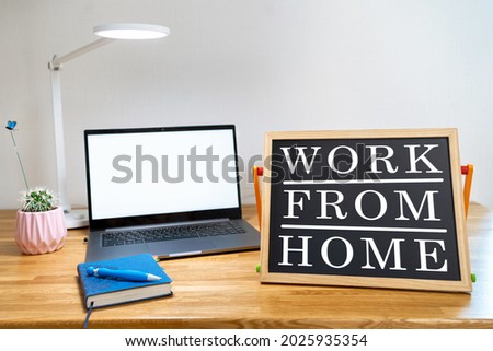 Working from home remote work inspirational social media lightbox message board next to laptop and sketchpad ​for COVID-19 quarantine closure of all businesses.