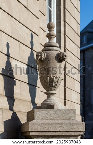 Beautiful stone urn and its shadow on top of column with patrimonial building in the background, old town, Quebec City, Quebec, Canada Royalty-Free Stock Photo #2025937043