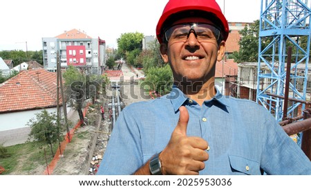 Engineer, during the construction of new apartments and the reconstruction of the city heating system, showing thumbs up