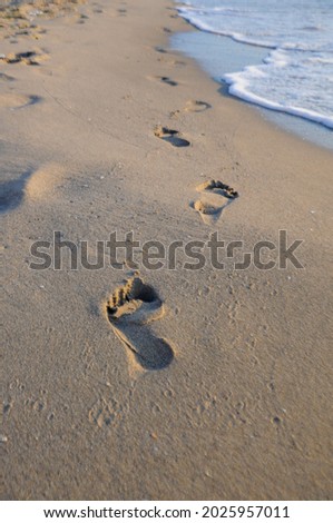 Human footprints on the sandy beach in Spain