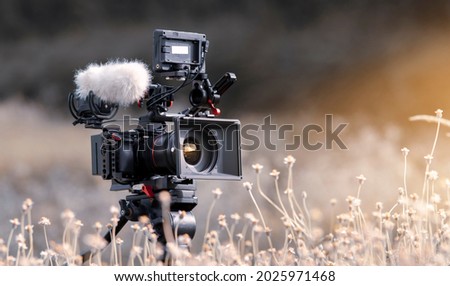 Digital Camera and sound recording equipment on the lawn.Documentary filming Royalty-Free Stock Photo #2025971468