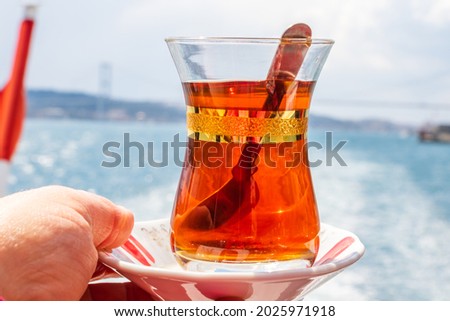 hand with turkish tea cup and flag. Travel concept