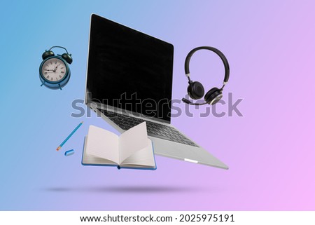 Creative minimal composition made with a laptop, headphones, school supplies and alarm clock  flying in the air. Back to school. Online teaching.  Suitable for advertising, marketing, ads. Copy space Royalty-Free Stock Photo #2025975191