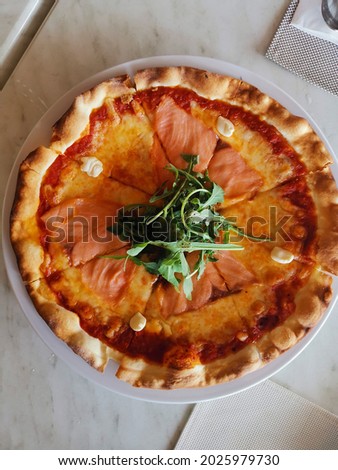 Top view of freshly Salmon Pizza on white marble table  