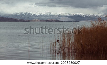 View of the lake and snow-capped mountains in Mongolia.