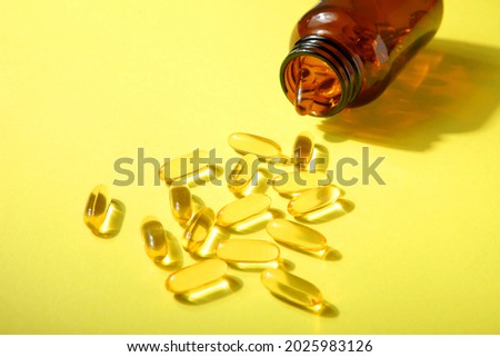 Omega 3 capsules on a colored background close-up with place for text.
