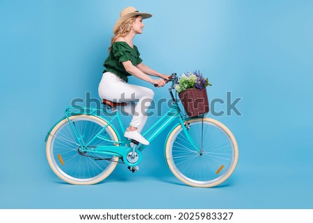 Profile photo of carefree traveler lady ride bicycle wear hat bear shoulders blouse isolated blue color background