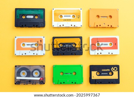 MANY VINTAGE CASSETTE AUDIO TAPES LOOPS ISOLATED ON YELLOW BACKGROUND. Royalty-Free Stock Photo #2025997367