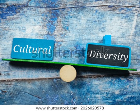 Text Cultural Diversity writing on colored wooden board on a blue wooden background. Trending photos concept.