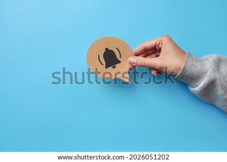 A conversational cloud and a bell icon in it. An Internet channel subscription symbol and a subscription reminder Royalty-Free Stock Photo #2026051202