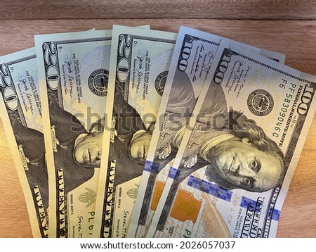 spreading dollar bills over counter
