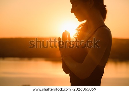 Woman portrait raise hands and face close up in warm sun light outdoor, yoga meditation practice Royalty-Free Stock Photo #2026065059