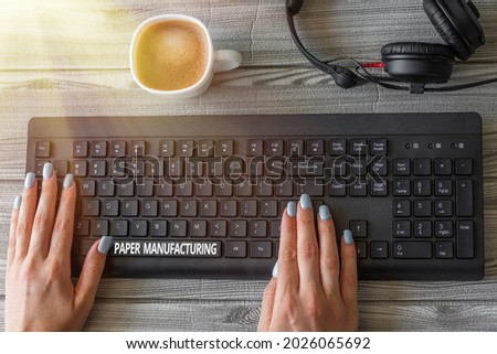 Conceptual caption Paper Manufacturing. Conceptual photo company that use wood as raw material and produce paper Keyboard Over A Table Beside A Ceramic Cup Filled With Hot Brew.