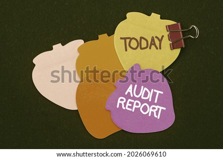 Handwriting text Audit Report. Conceptual photo An appraisal of complete financial status of a business Assets Multiple assorted collection office stationery photo placed over table