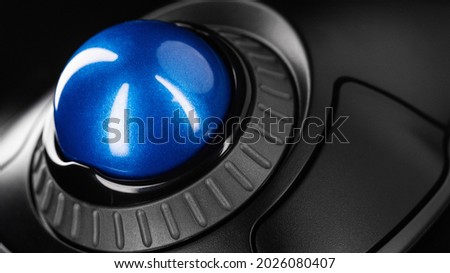 Trackball Computer Mouse on a blue background. Control Device with Scroll Wheel Royalty-Free Stock Photo #2026080407