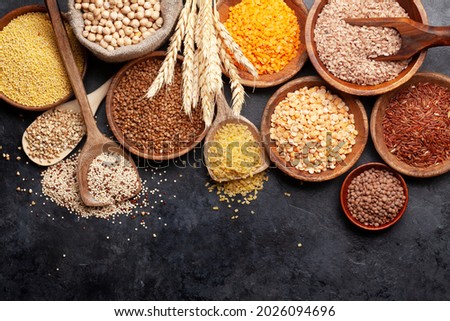 Gluten free cereals. Rice, buckwheat, corn groats, quinoa and millet in wooden bowls. Top view flat lay with copy space Royalty-Free Stock Photo #2026094696
