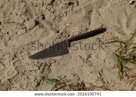 Rusty medieval knife on the sand