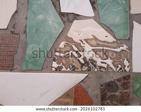 photo of the floor with a background of colorful ceramic pieces