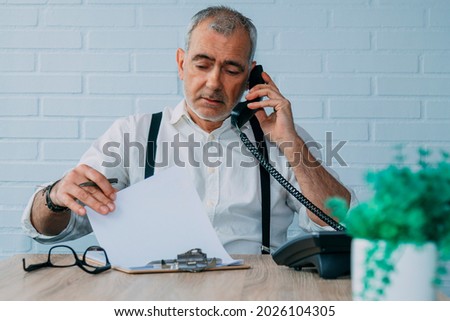 hipster man with landline phone working at home or office