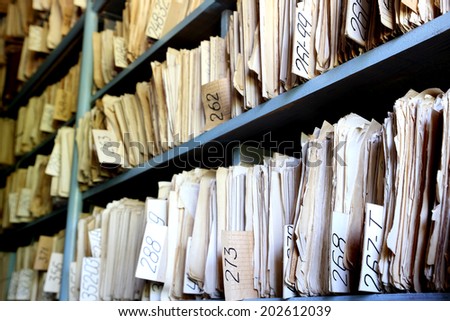 shelves full of files in an old archive Royalty-Free Stock Photo #202612039