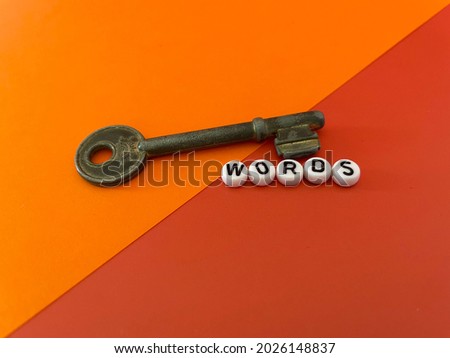 Key with text words on a colored background. Keyword research concept