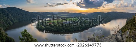 Vltava river horseshoe shape meander from Albert viewpoint close to Smilovice,Czech Republic.Beautiful landscape with river canyon at sunset.Panoramic view of Czech countryside with water reflection Royalty-Free Stock Photo #2026149773
